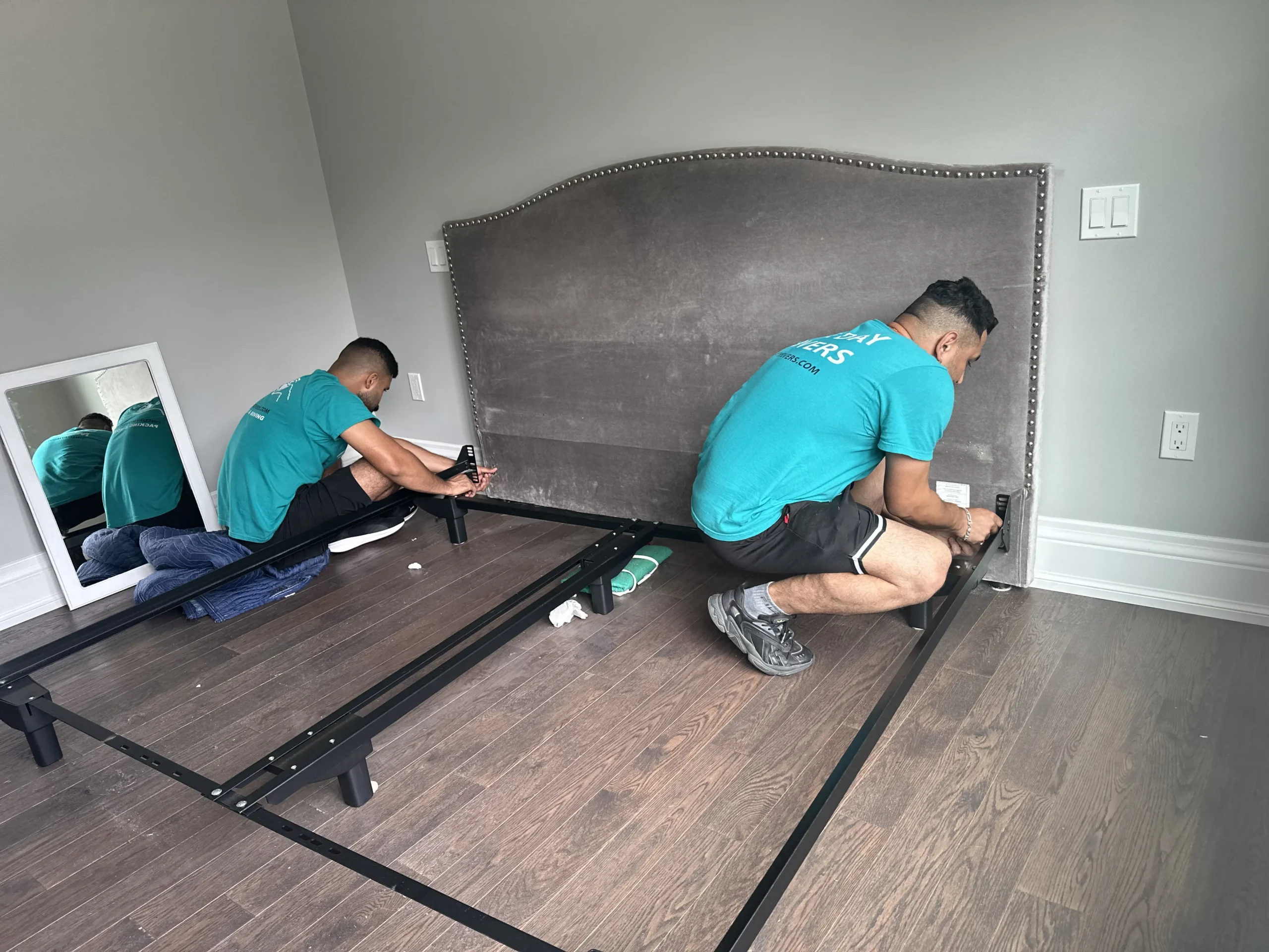 Movers rearranging furniture during in-house move Toronto