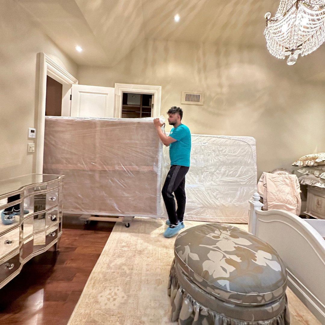 Professional white glove movers handling heavy equipment